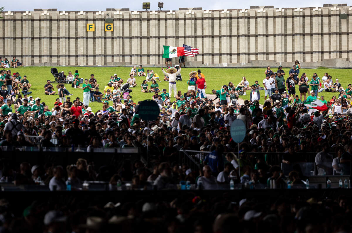Tiskani Perez holds a USA and Mexican flag during the FIFA Fan Festival at Fair Park in Dallas, June 11, 2026.